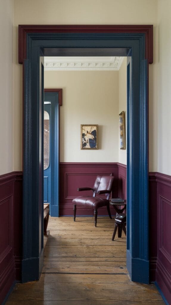 Interior view of a hallway with burgundy and blue paneling, featuring a vintage chair and framed artwork