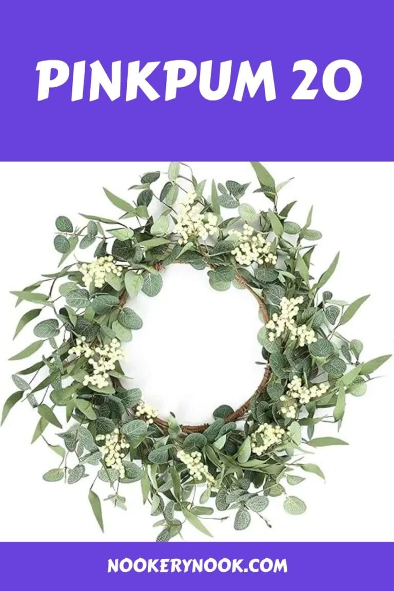 Decorative green wreath with white berries, perfect for home decor and seasonal celebrations. Ideal for entryways or walls.