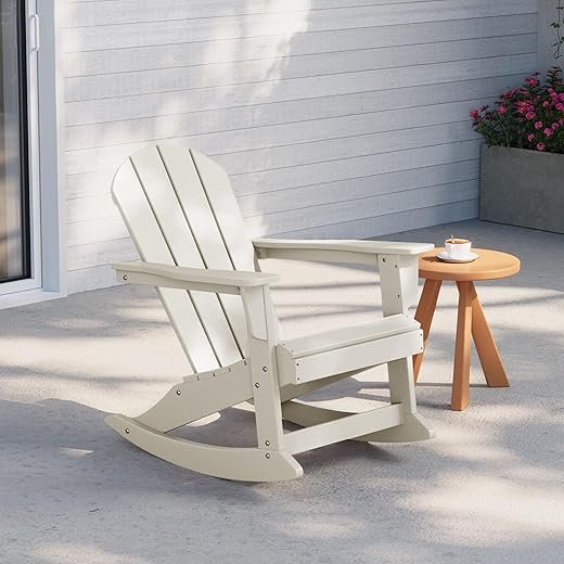 Light-colored rocking chair on a patio beside a small table, perfect for outdoor relaxation and leisure.