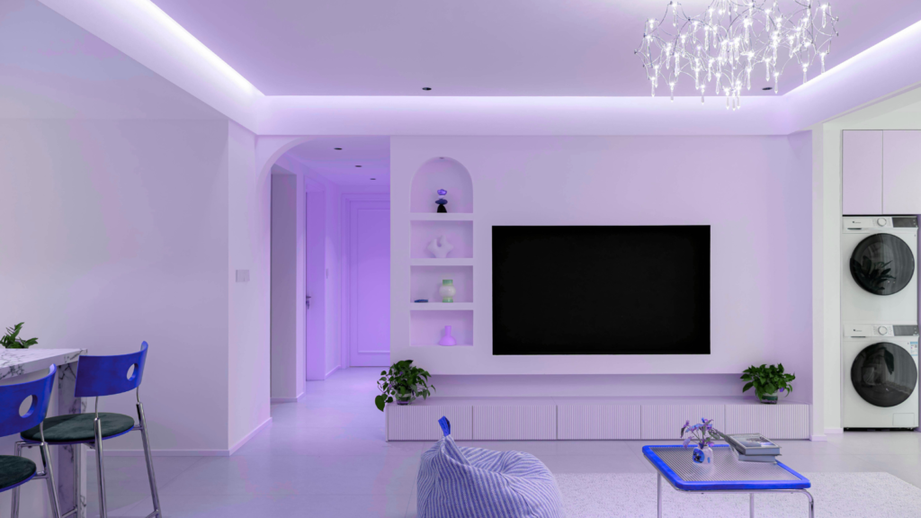 Modern living room with purple lighting, minimalist decor, and a stylish entertainment area featuring a large TV and plants.